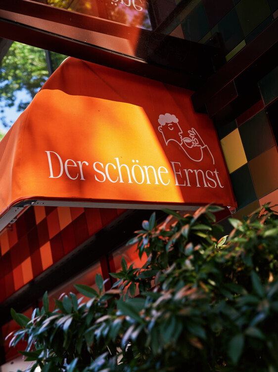 Die orange Markise des schönen Ernst leuchtet in der Abendsonne.